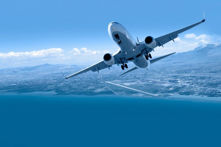 an airplane soaring across the sky on top of a city