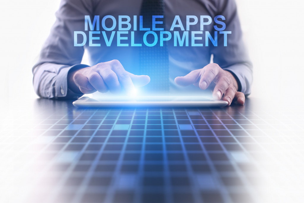 Businessman using a tablet PC and select Mobile apps development