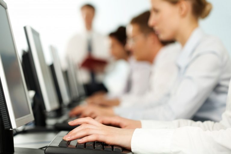 employees blurred faces working on computers
